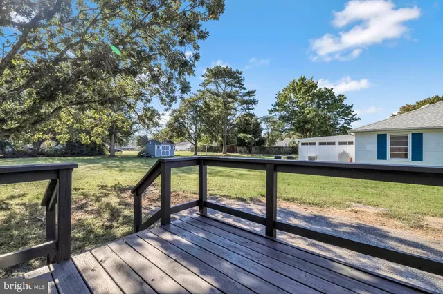 a view of a wooden deck and a yard