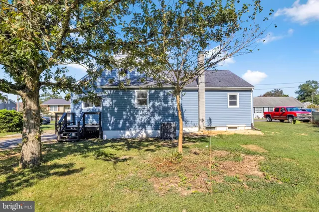 a view of a house with a yard patio and fire pit