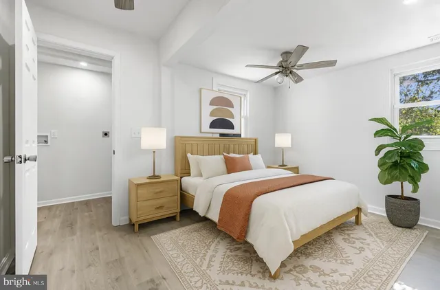 a bedroom with a bed and a potted plant