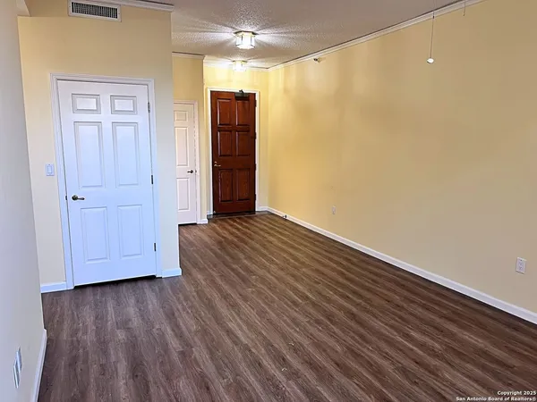 a view of hallway with wooden floor