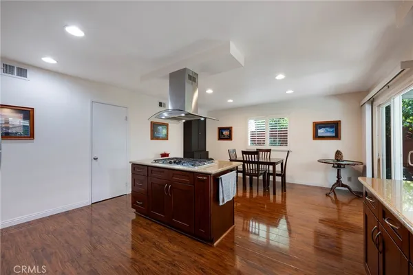 a kitchen with granite countertop a sink and a wooden cabinets