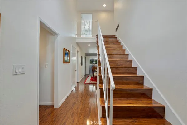 a bathroom with a granite countertop toilet a sink and a mirror