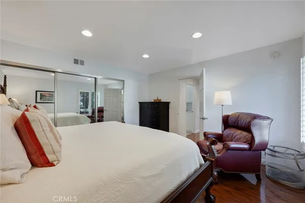 a view of a big room with wooden floor and windows