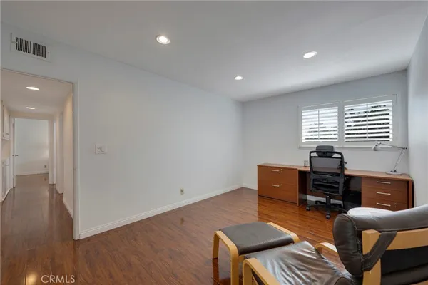 a bathroom with a granite countertop sink a toilet and a mirror