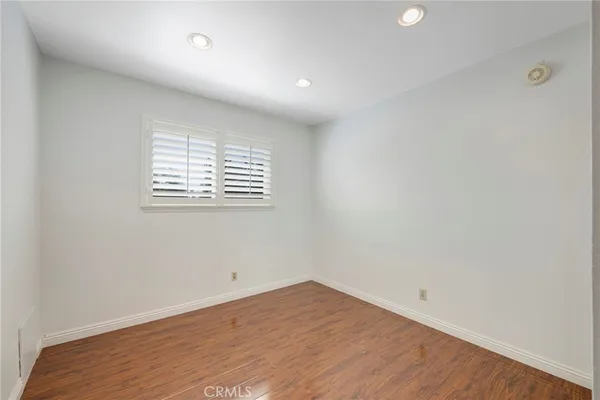 a bedroom with a bed and glass door