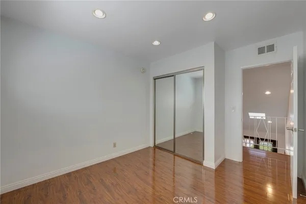 a view of a patio with table and chairs potted plants and floor to ceiling window