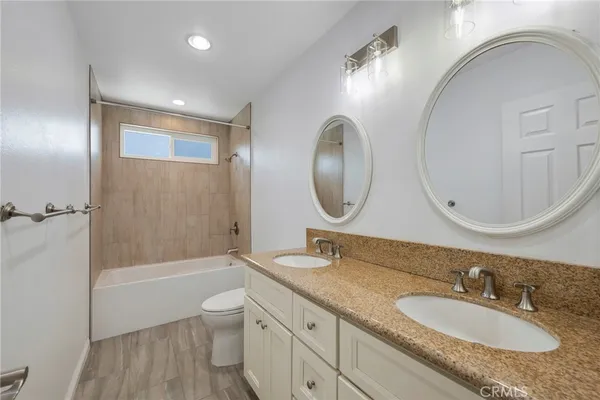 a view of a backyard with potted plants and a large tree