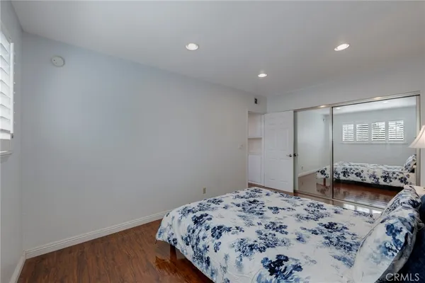 a view of a patio with table and chairs potted plants with wooden floor and fence