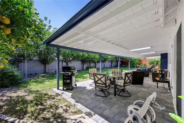 a view of a patio with couches chairs and a yard