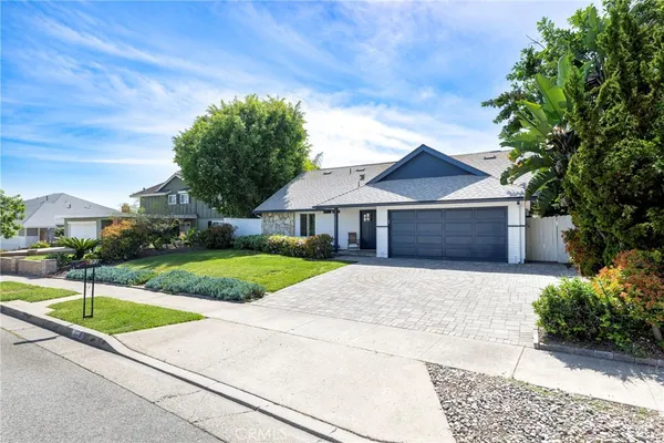 a open kitchen with stainless steel appliances kitchen island granite countertop a table chairs and wooden floors