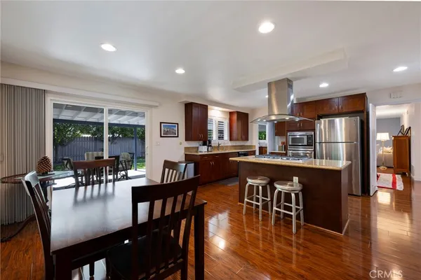 a kitchen with stainless steel appliances granite countertop a refrigerator a sink and a stove