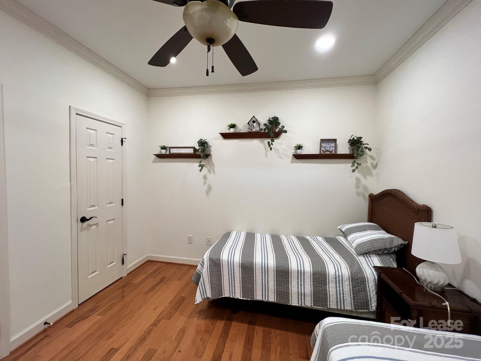 1140 Torrence Circle Davidson, NC 28036 - Photo 13 of 35 a bedroom with a bed and wooden floor