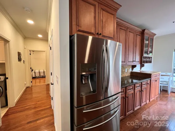 a kitchen with stainless steel appliances granite countertop a refrigerator stove and sink