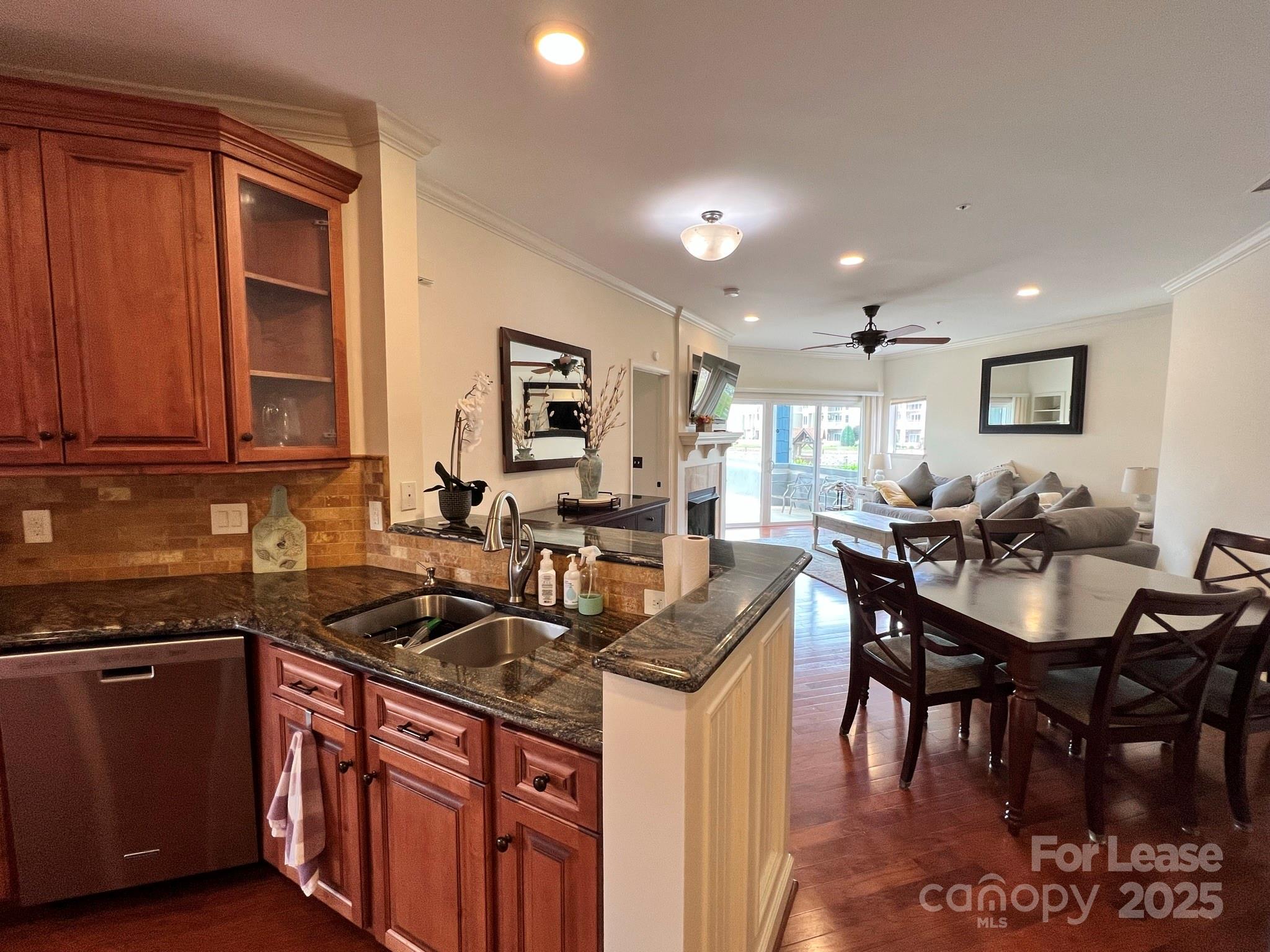 1140 Torrence Circle Davidson, NC 28036 - Photo 20 of 35 a kitchen with granite countertop a sink stove and cabinets