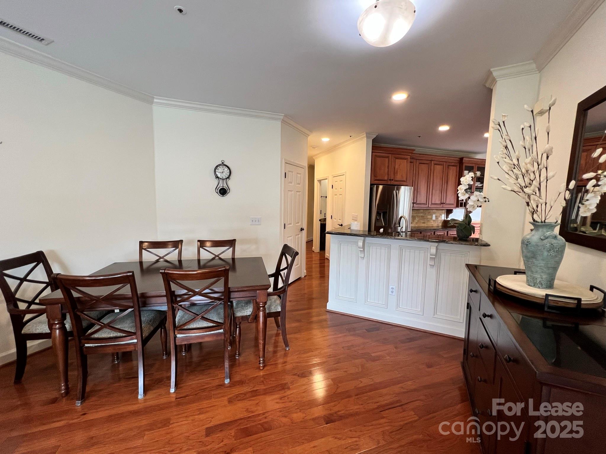 1140 Torrence Circle Davidson, NC 28036 - Photo 22 of 35 a view of a dining room with furniture and wooden floor