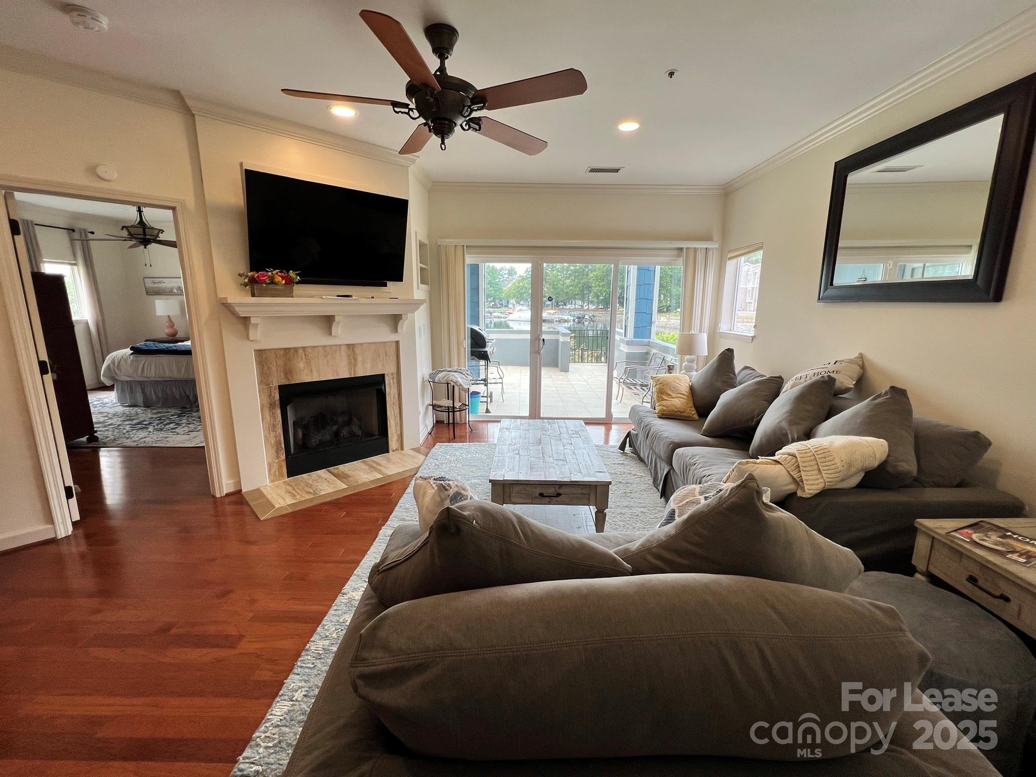 1140 Torrence Circle Davidson, NC 28036 - Photo 24 of 35 a living room with furniture a fireplace and a flat screen tv
