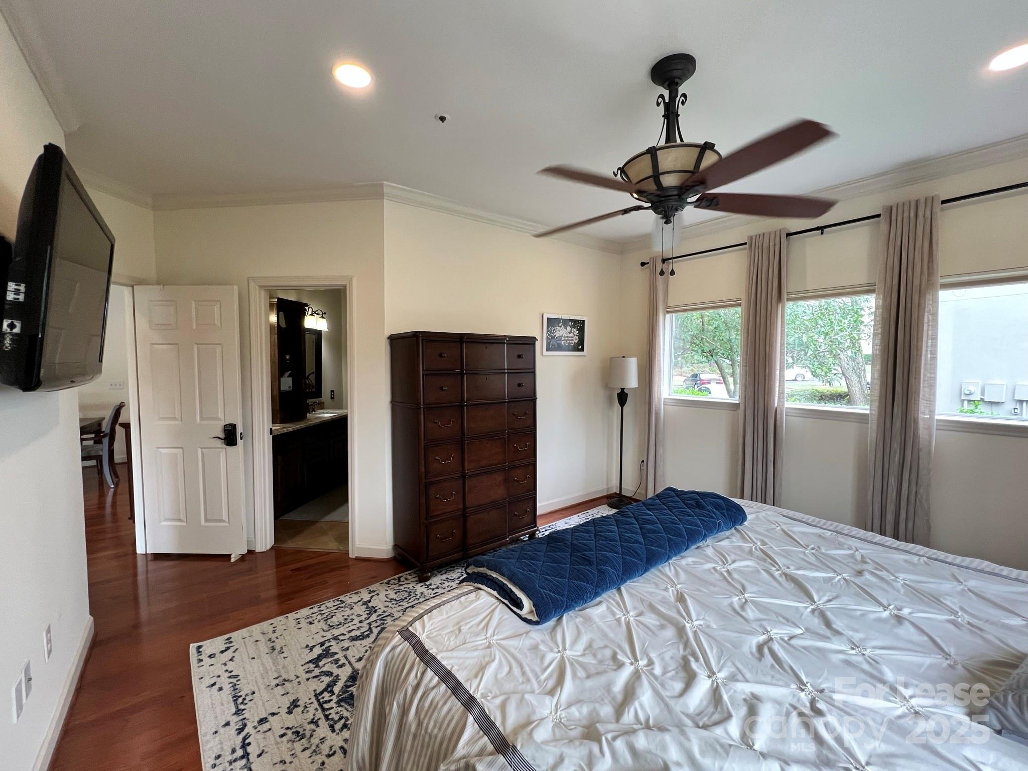 1140 Torrence Circle Davidson, NC 28036 - Photo 27 of 35 a bedroom with a bed and a flat screen tv