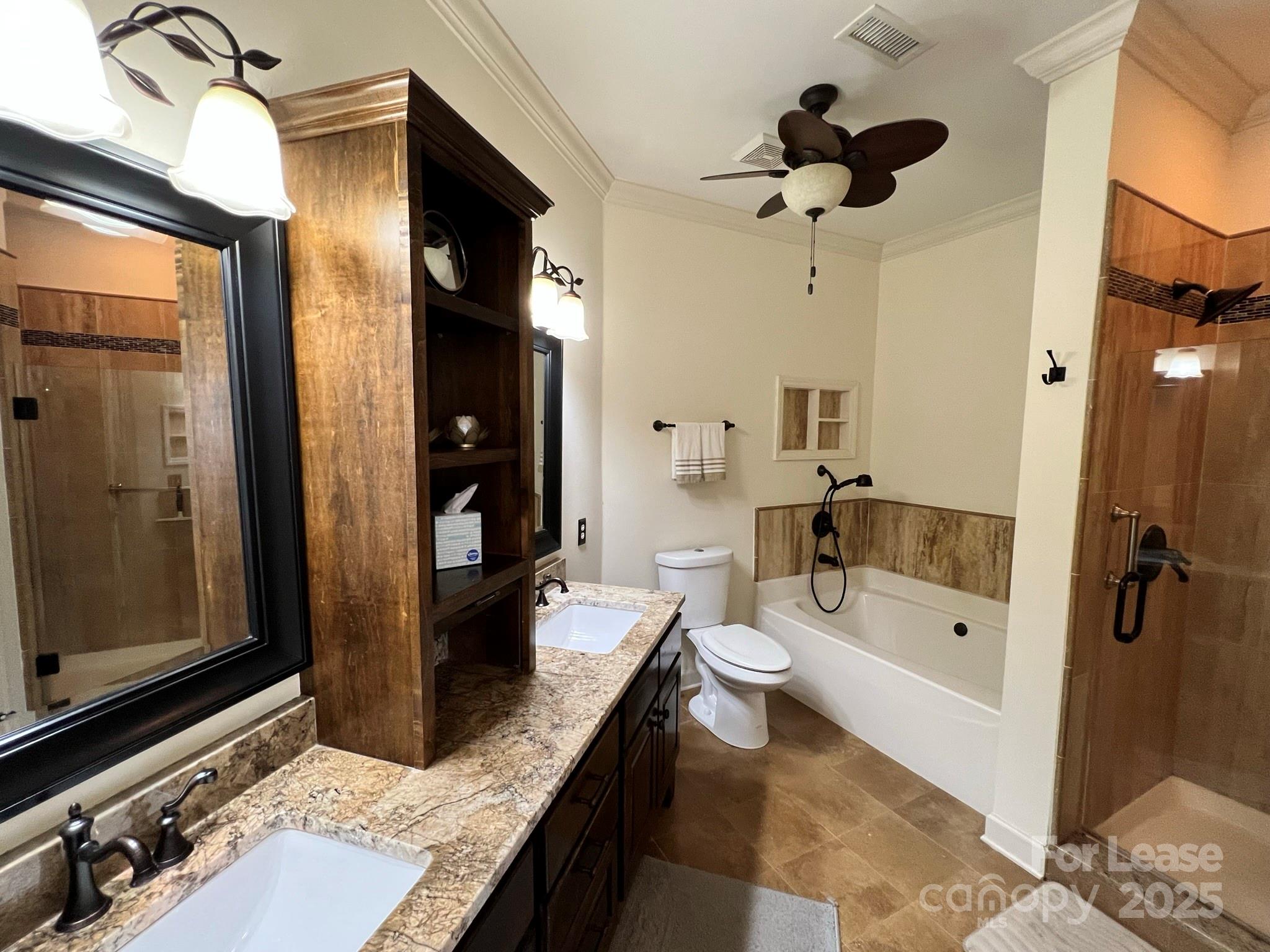 1140 Torrence Circle Davidson, NC 28036 - Photo 28 of 35 a bathroom with a granite countertop sink a toilet and shower