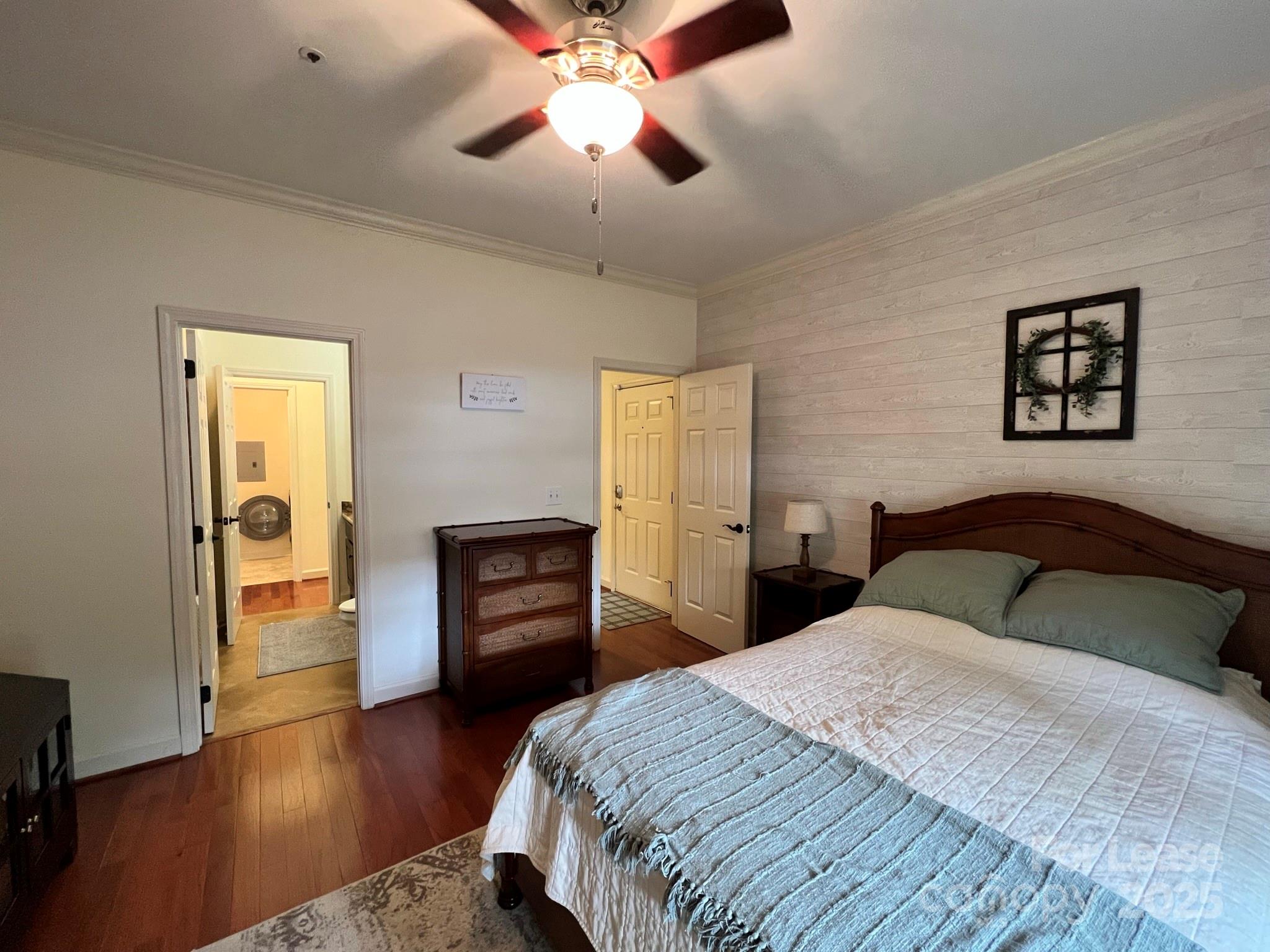 1140 Torrence Circle Davidson, NC 28036 - Photo 6 of 35 a bedroom with a bed and wooden floor