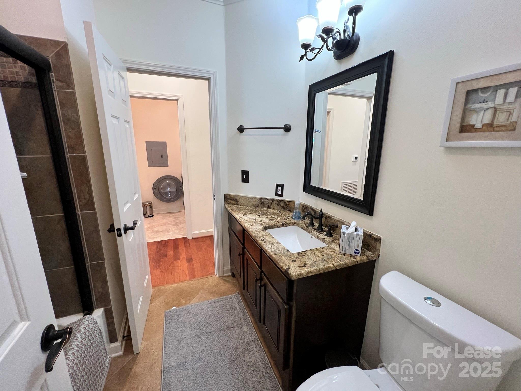 1140 Torrence Circle Davidson, NC 28036 - Photo 7 of 35 a bathroom with a sink toilet and mirror