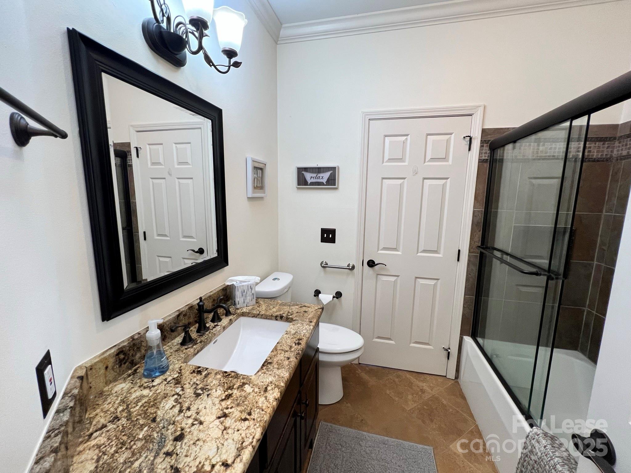 1140 Torrence Circle Davidson, NC 28036 - Photo 8 of 35 a bathroom with a sink a toilet a mirror and shower