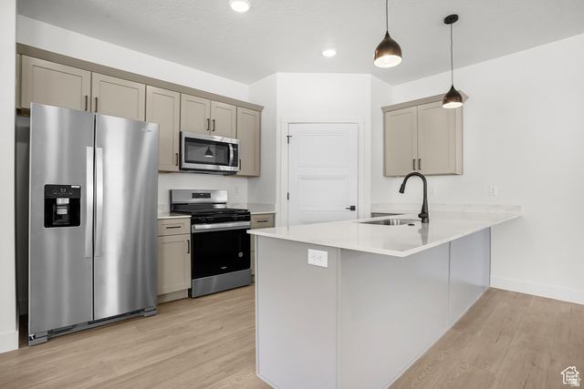 1631 West Century Lane, Unit C Mapleton, UT 84664 - Photo 8 of 31 Contemporary kitchen featuring a light gray island with a stainless steel sink and matte black faucet, light wood-finish flooring, and two-tone cabinetry with stainless steel appliances
