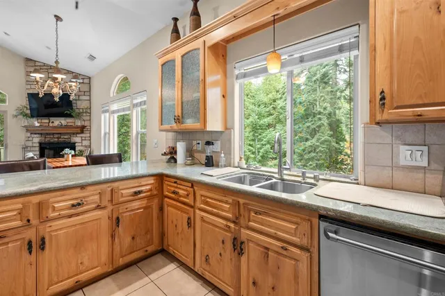a kitchen with a sink window and cabinets