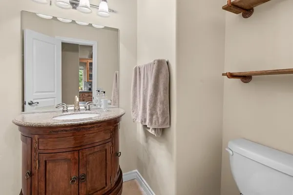 a bathroom with a sink a toilet and a mirror