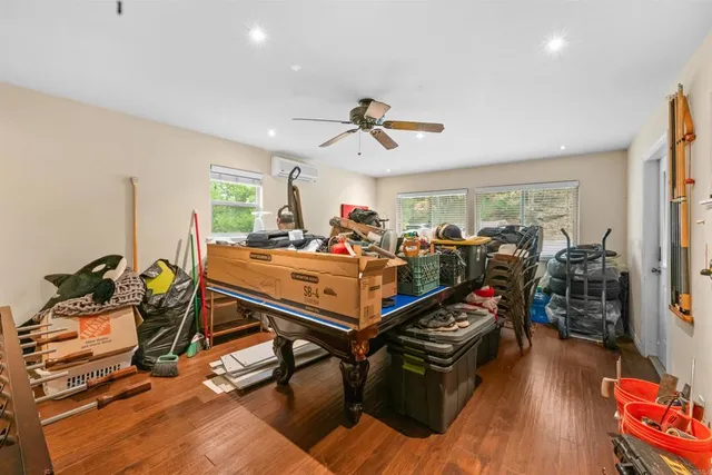 a room with gym equipment and wooden floor