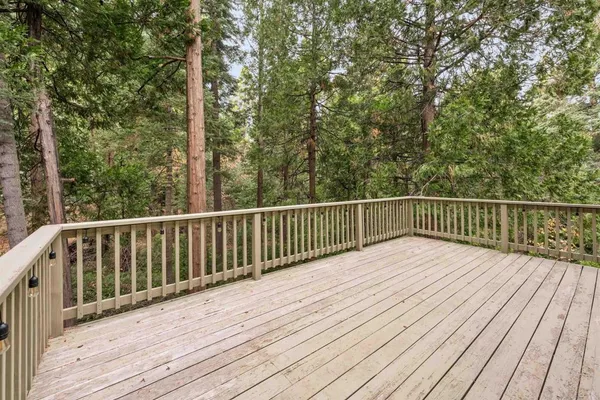 a view of balcony with wooden floor and fence