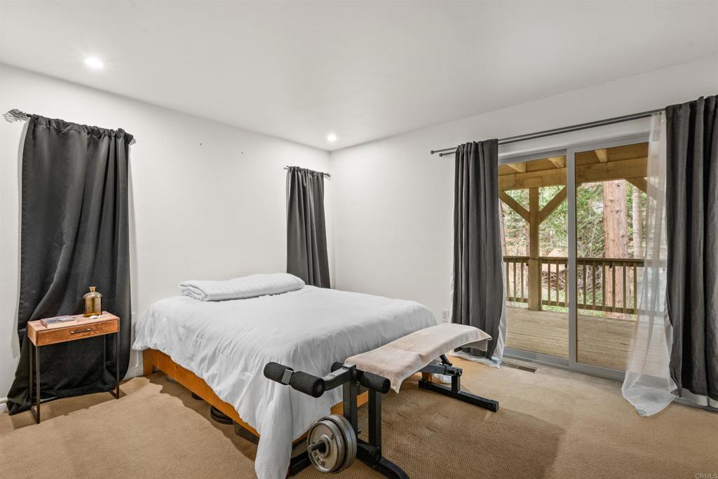 26328 Jacqueline Road Twin Peaks, CA 92391 - Photo 21 of 37 a bedroom with a bed and a large window