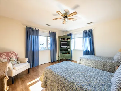 a bedroom with a large bed and a chandelier