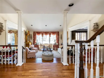 a living room with lots of furniture and a large window