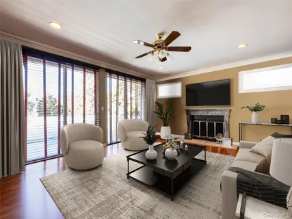 a living room with furniture fireplace and a large window