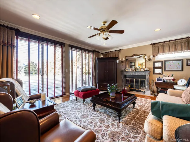 a living room with furniture a fireplace and a large window