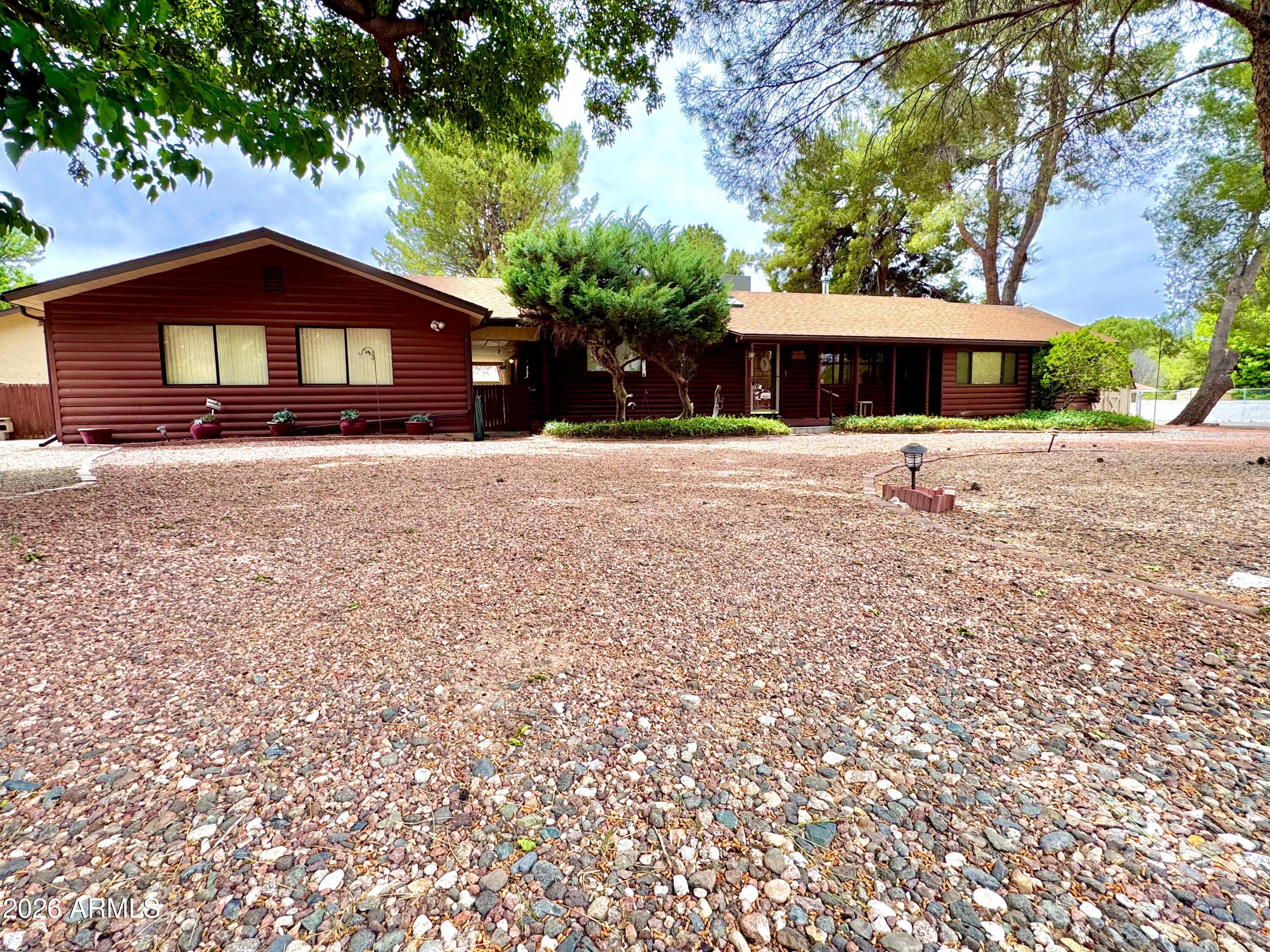 4310 North Lake View Drive Rimrock, AZ 86335 - Photo 1 of 43 a front view of a house with a yard and tree