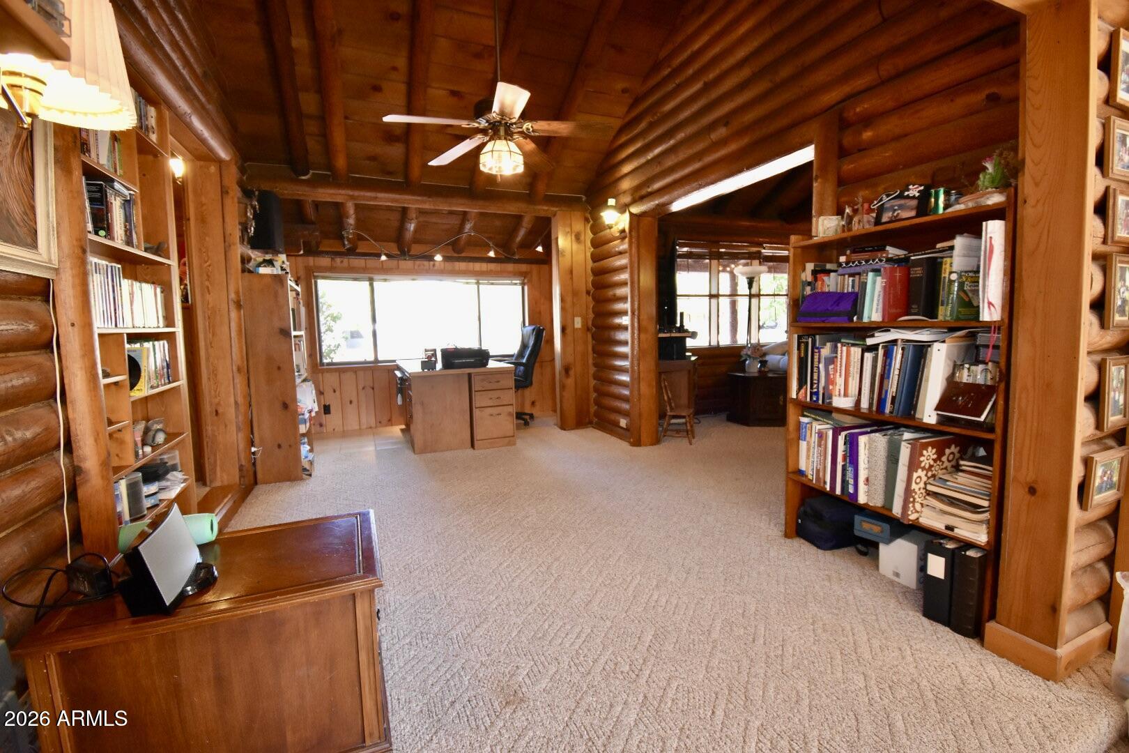 4310 North Lake View Drive Rimrock, AZ 86335 - Photo 11 of 43 a view of an empty room with furniture and a book shelf