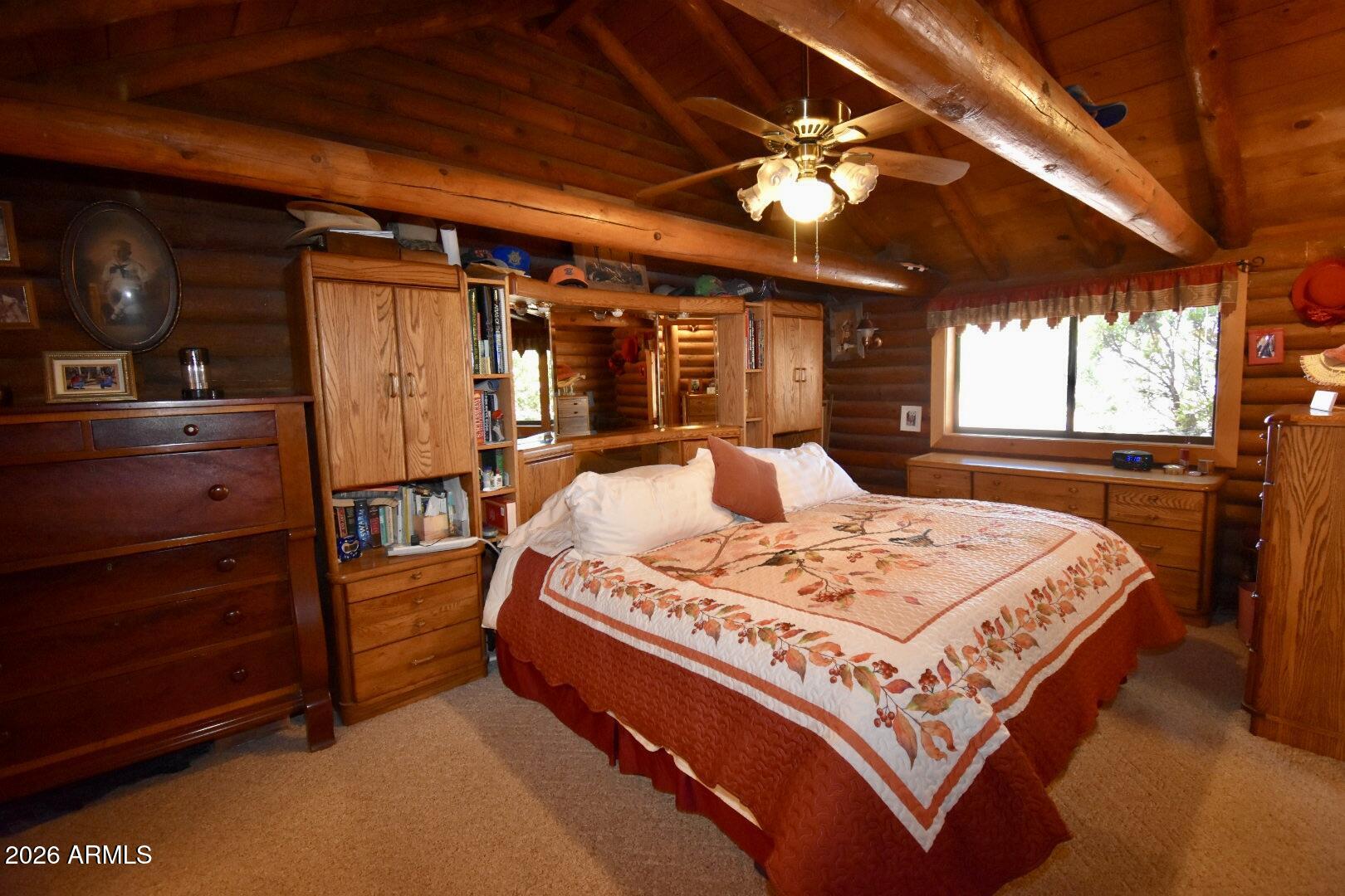 4310 North Lake View Drive Rimrock, AZ 86335 - Photo 14 of 43 a bed sitting in a bedroom next to a window