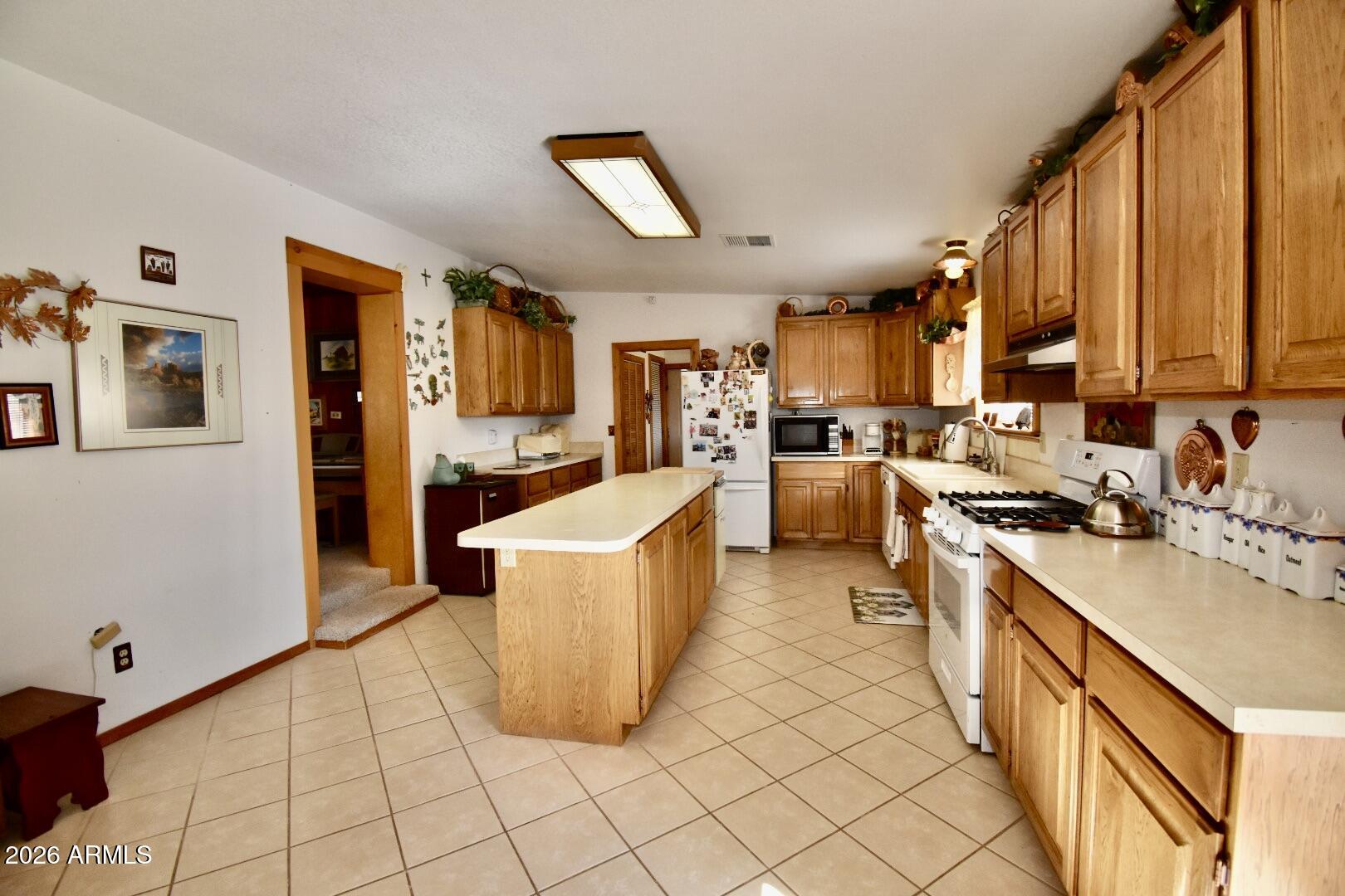 4310 North Lake View Drive Rimrock, AZ 86335 - Photo 23 of 43 a kitchen with stainless steel appliances a stove top oven a sink a counter top space and cabinets