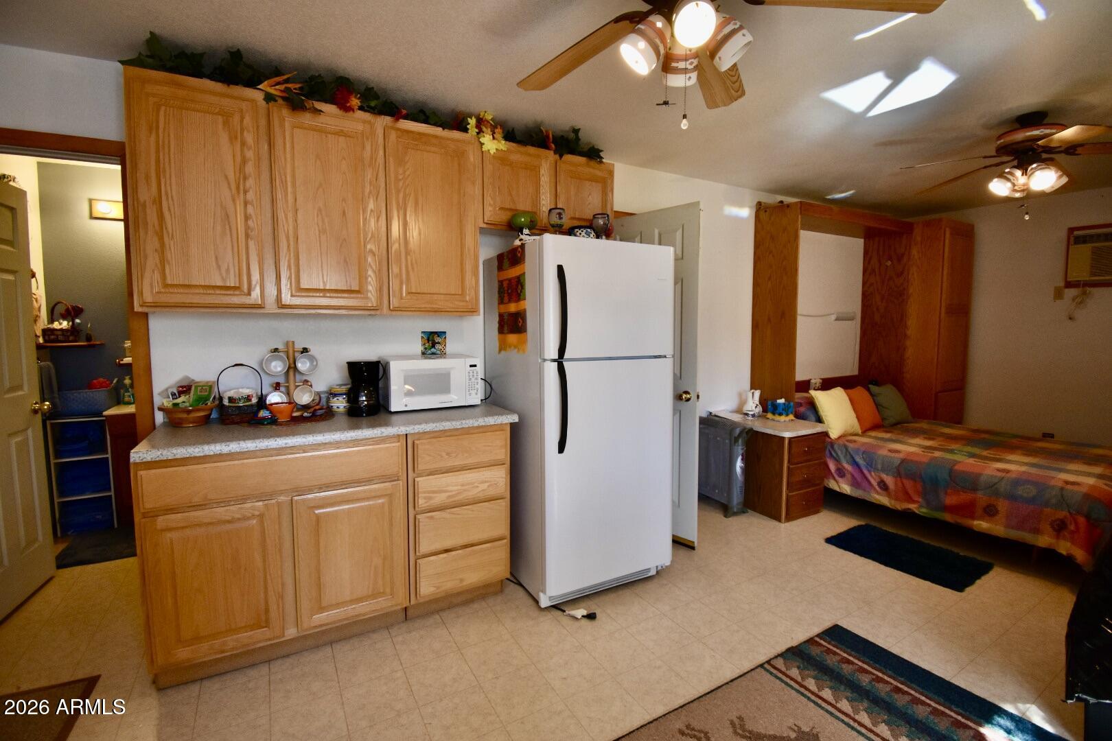 4310 North Lake View Drive Rimrock, AZ 86335 - Photo 32 of 43 a bedroom with a bed and a refrigerator