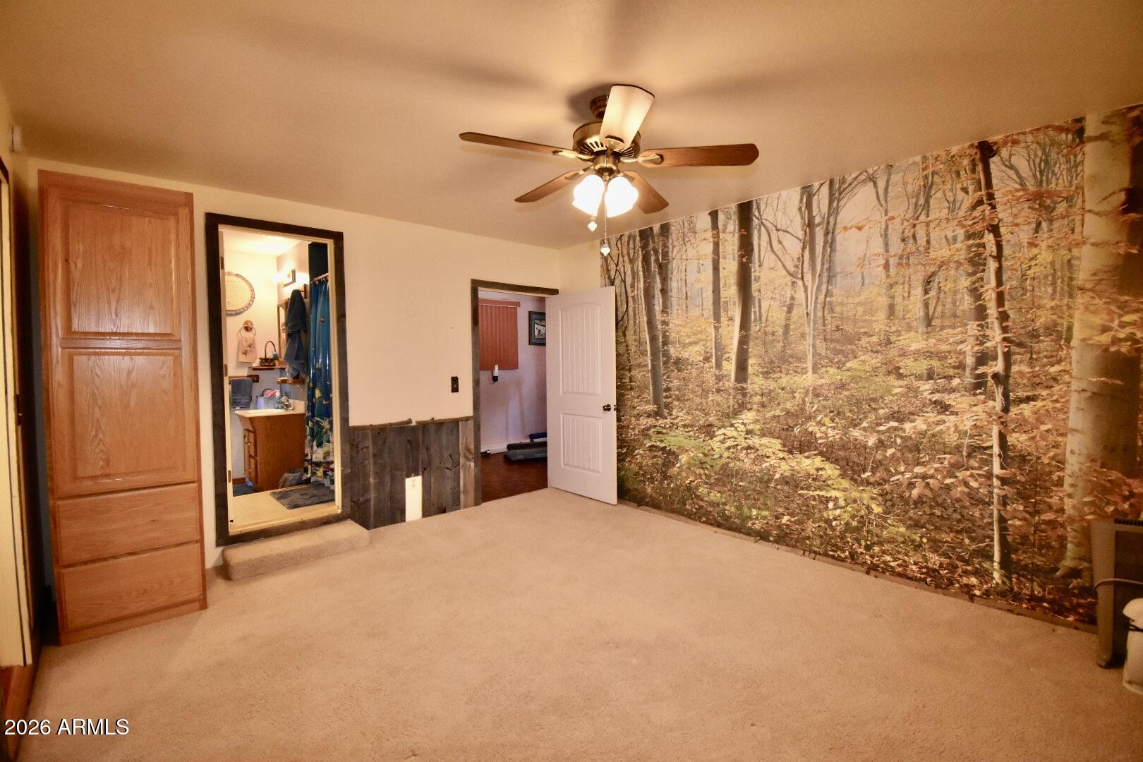 4310 North Lake View Drive Rimrock, AZ 86335 - Photo 35 of 43 a bedroom with a bed and a chandelier