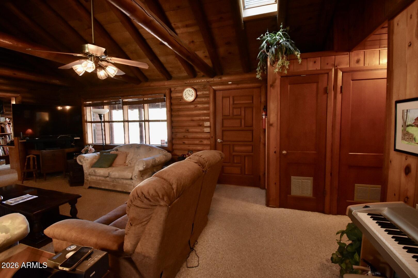 4310 North Lake View Drive Rimrock, AZ 86335 - Photo 6 of 43 a living room with furniture a chandelier and a projector