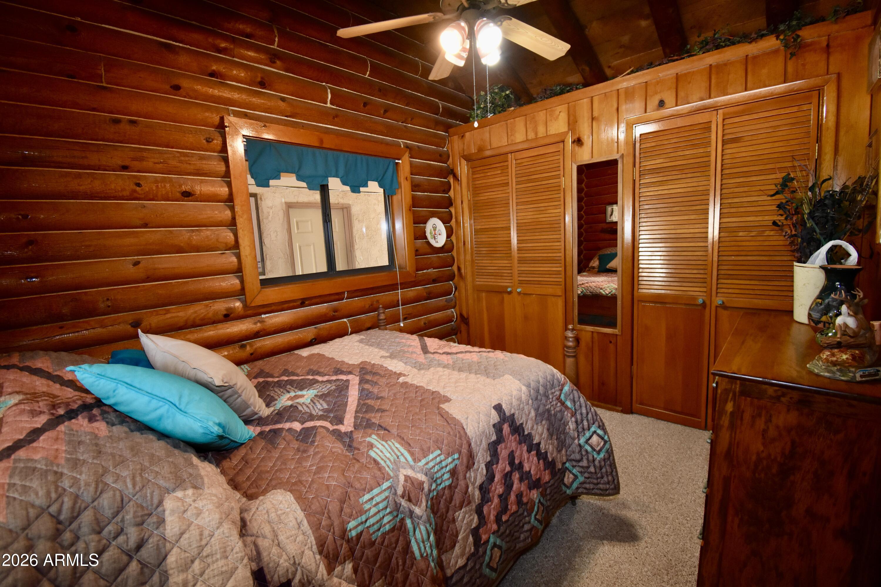 4310 North Lake View Drive Rimrock, AZ 86335 - Photo 9 of 43 a bedroom with a bed and wooden floor