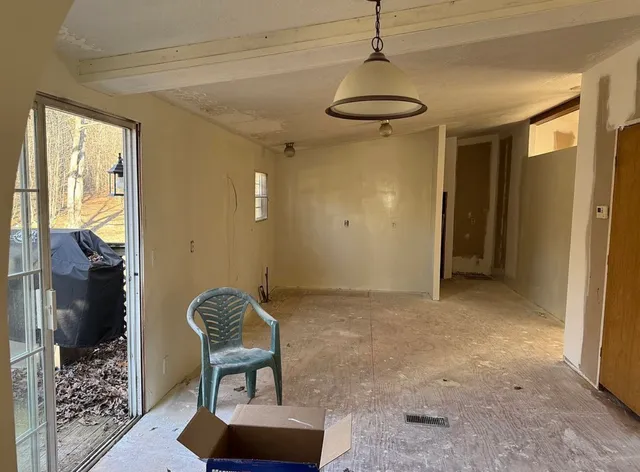 a view of a hallway with furniture and a chandelier