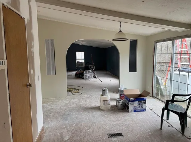 a view of livingroom with furniture and large windows