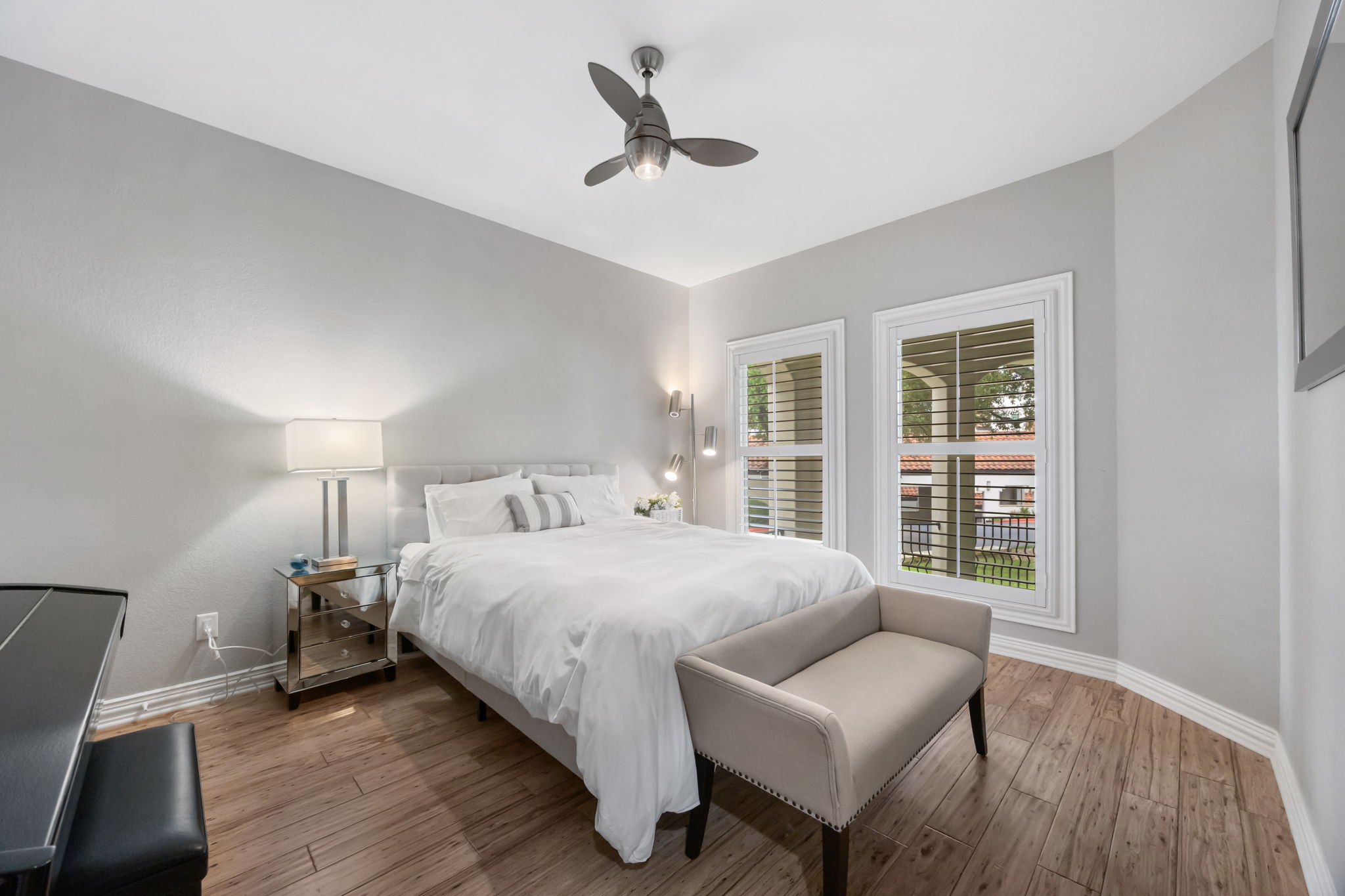 1910 Rue De St Tropez, Unit 6 Austin, TX 78746 - Photo 26 of 37 Hardwood floors and bright windows illuminate this comfortable, well-appointed primary suite.