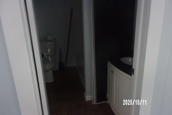 a kitchen with granite countertop white cabinets and refrigerator