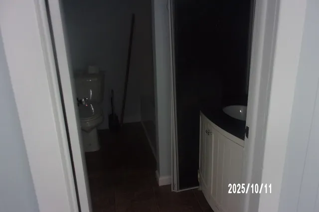 a kitchen with granite countertop white cabinets and refrigerator