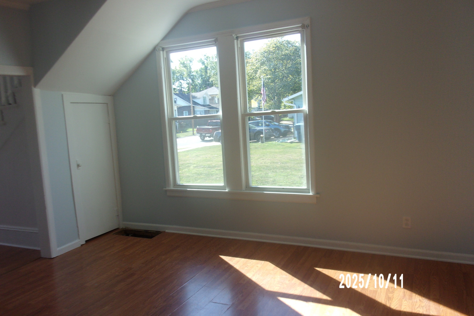 466 East Cherry Street Watseka, IL 60970 - Photo 8 of 25 a view of an empty room with wooden floor and a window