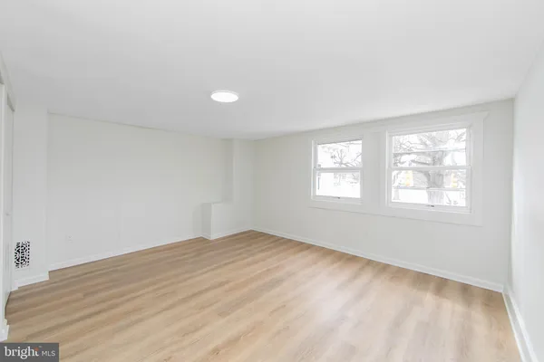 a view of an empty room and closet area